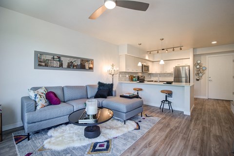 a living room and kitchen with a couch and a table
